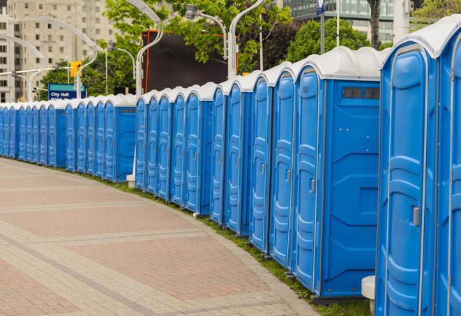 a row of portable restrooms set up for a large athletic event, allowing participants and spectators to easily take care of their needs in South Farmingdale